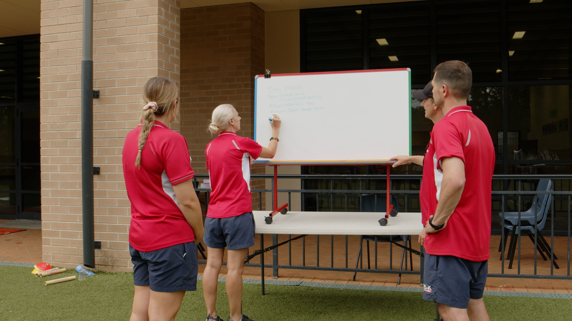 Physical educators working on a whiteboard